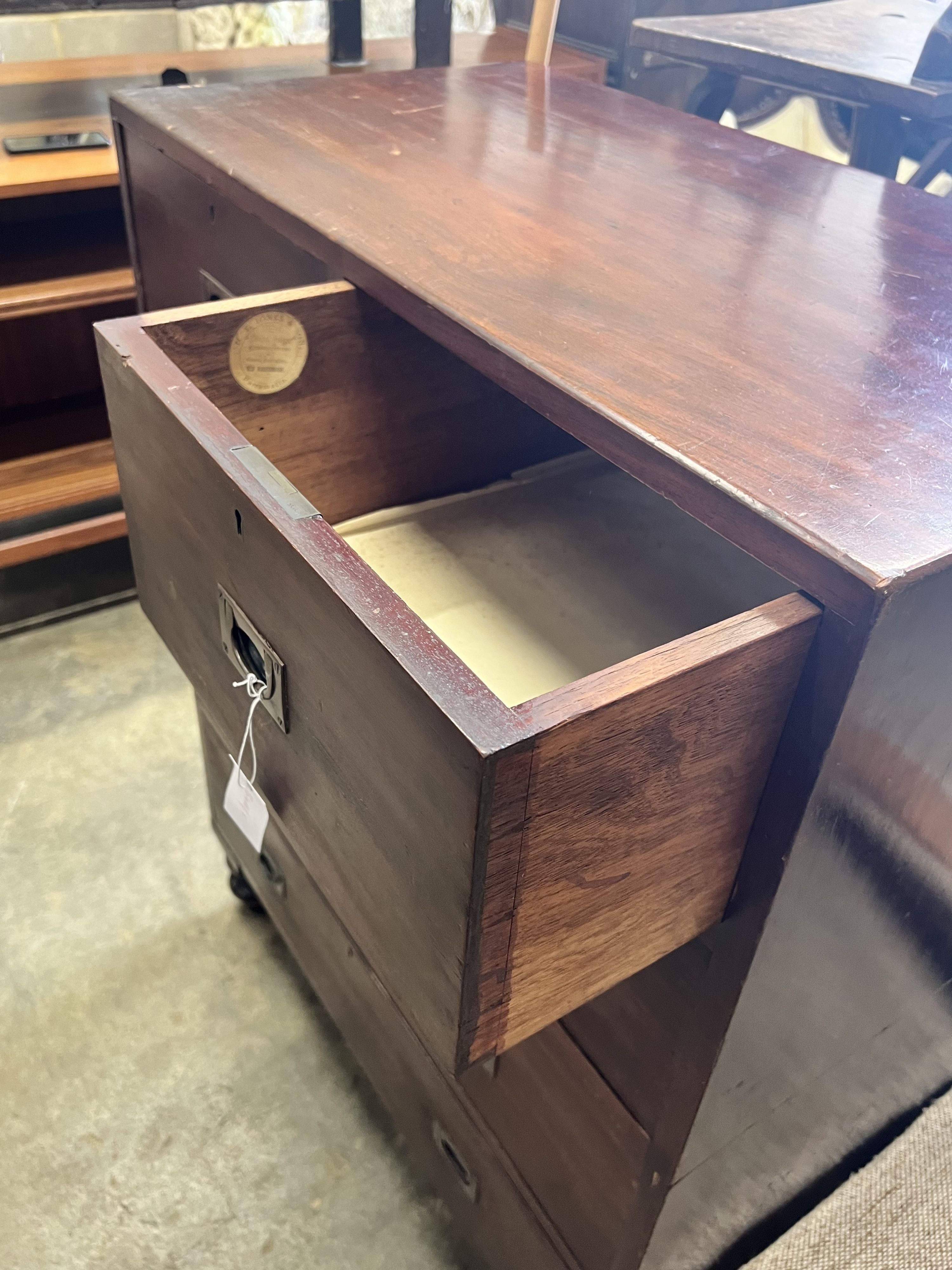 A 19th century teak two part military chest, bears paper label H.T. Jones & Sons, Parramatta, width 86cm depth 46cm height 113cm